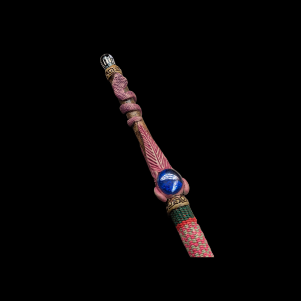 A tube made of bamboo. The face of a shaman in glasses